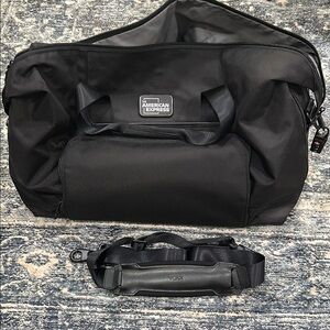 TUMI Black Duffel Bag with Durable Fabric, combo lock, QR locator
